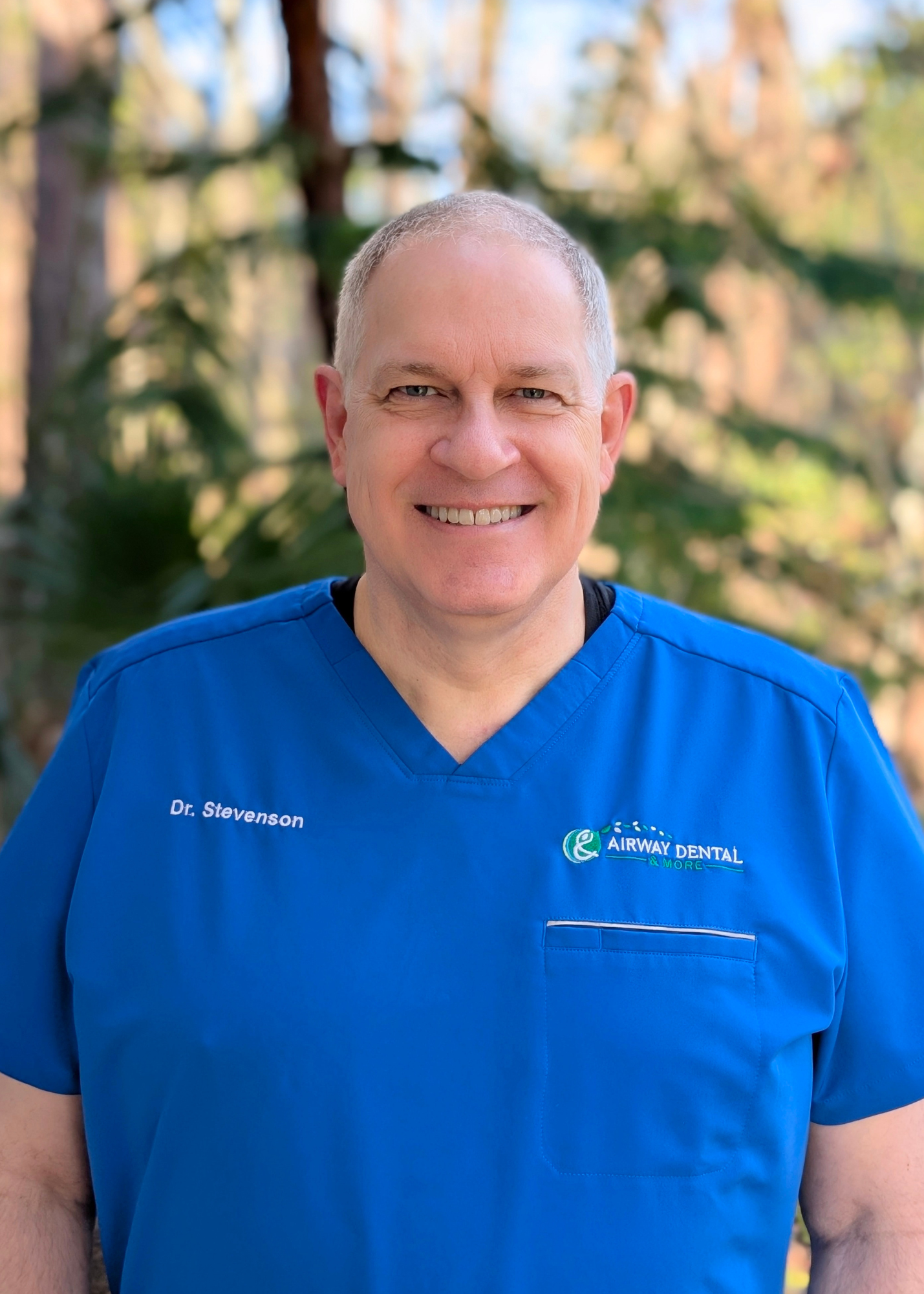 Dr. Neil Stevenson in blue scrubs